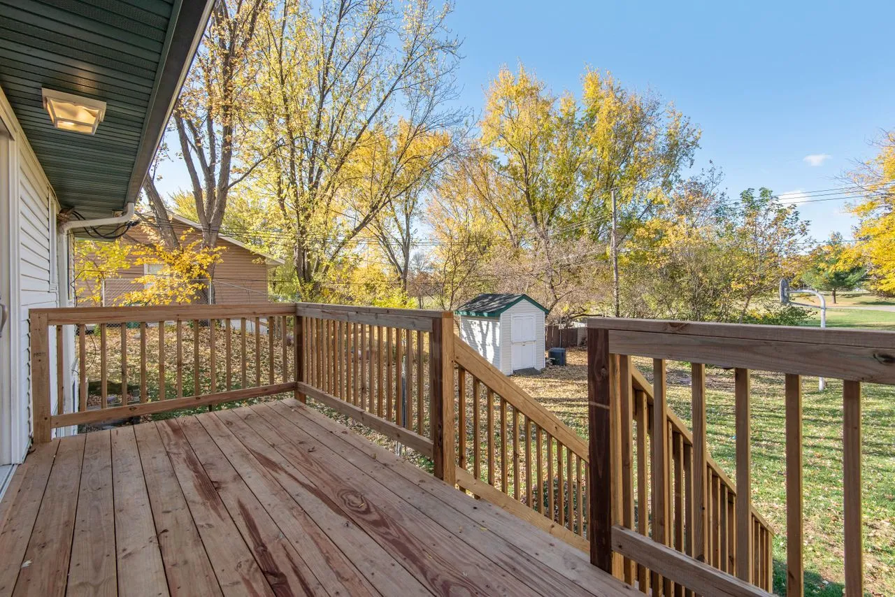A finished backyard wood deck on a clear day