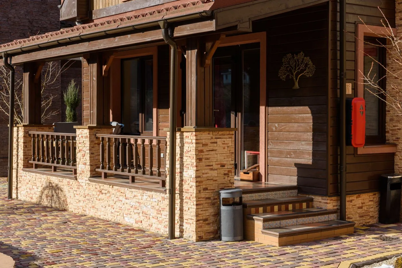 A home exterior with fresh siding, stone accents, and a covered porch