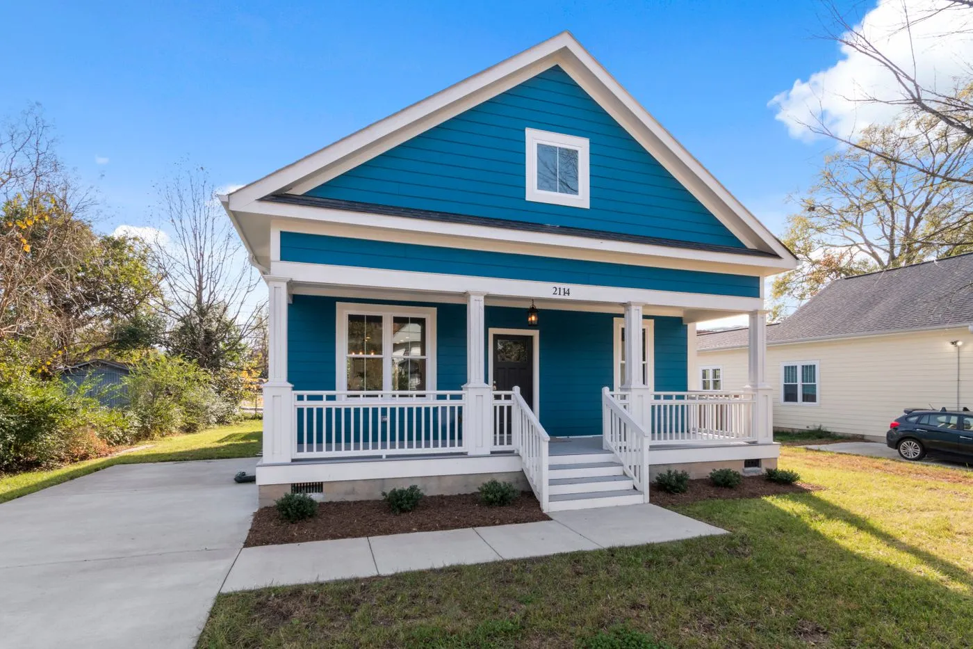 A suburban home with fresh lap siding and a covered front porch